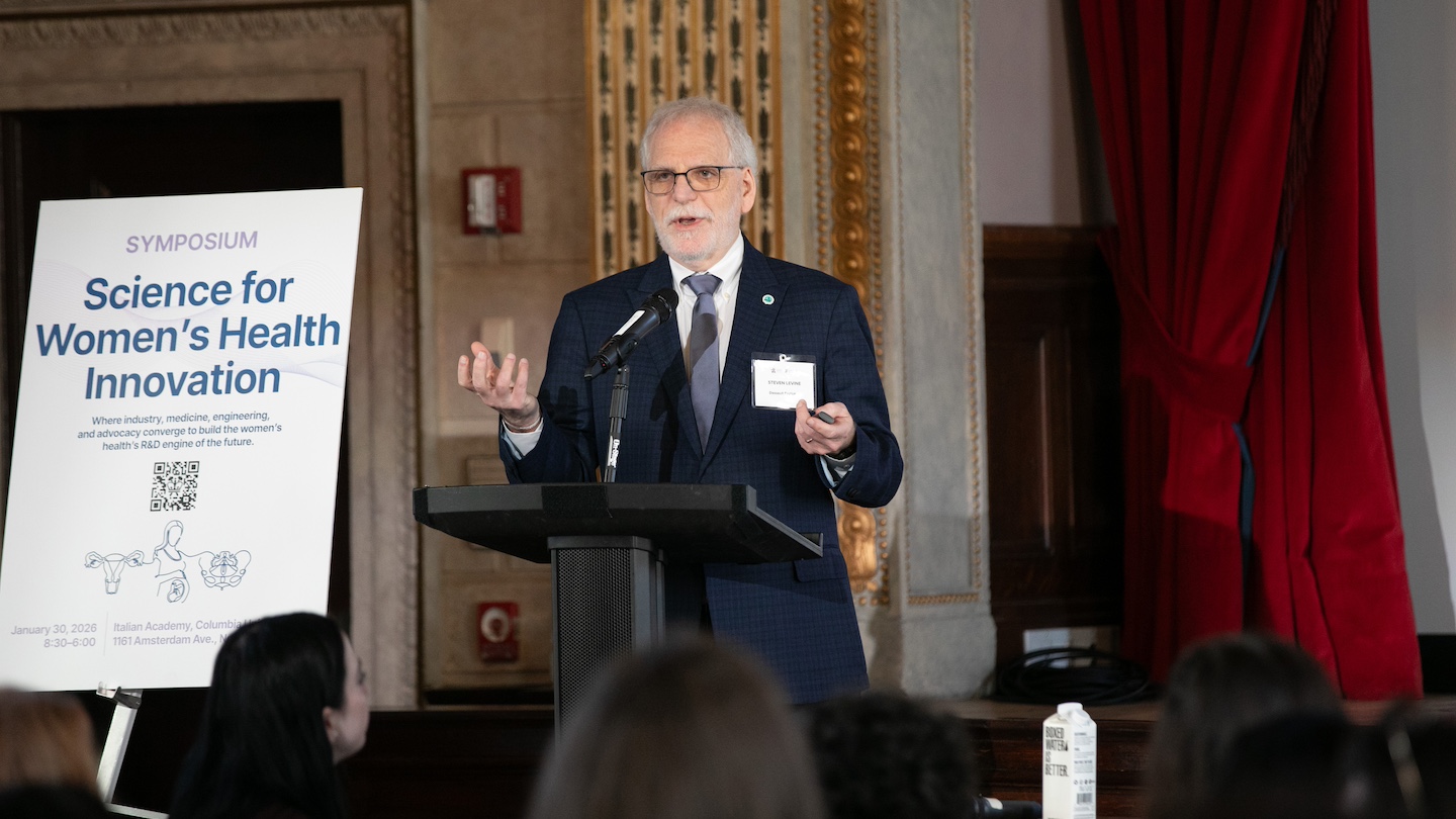 Women's health symposium speaker at podium