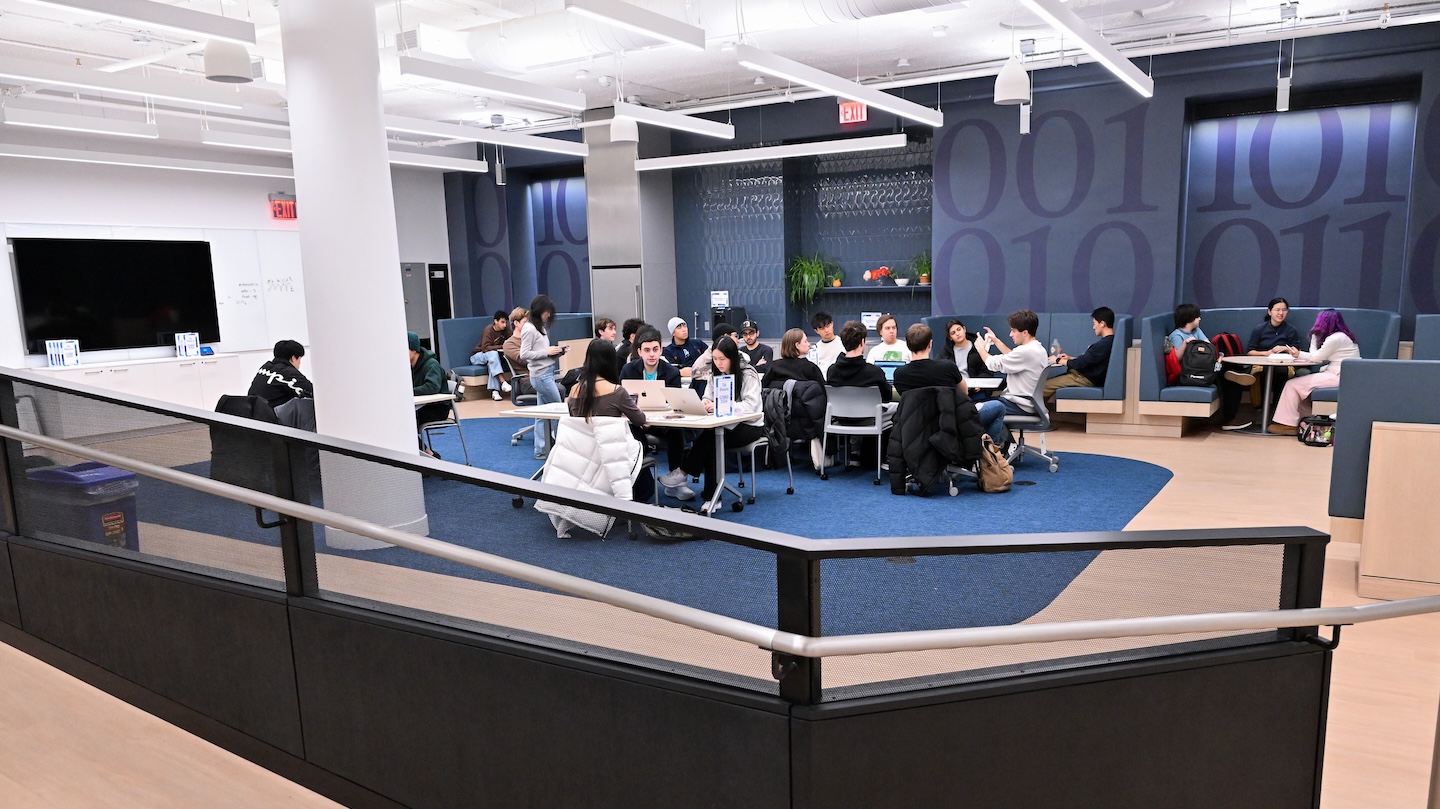 image of CS learning center lounge with students studying at tables