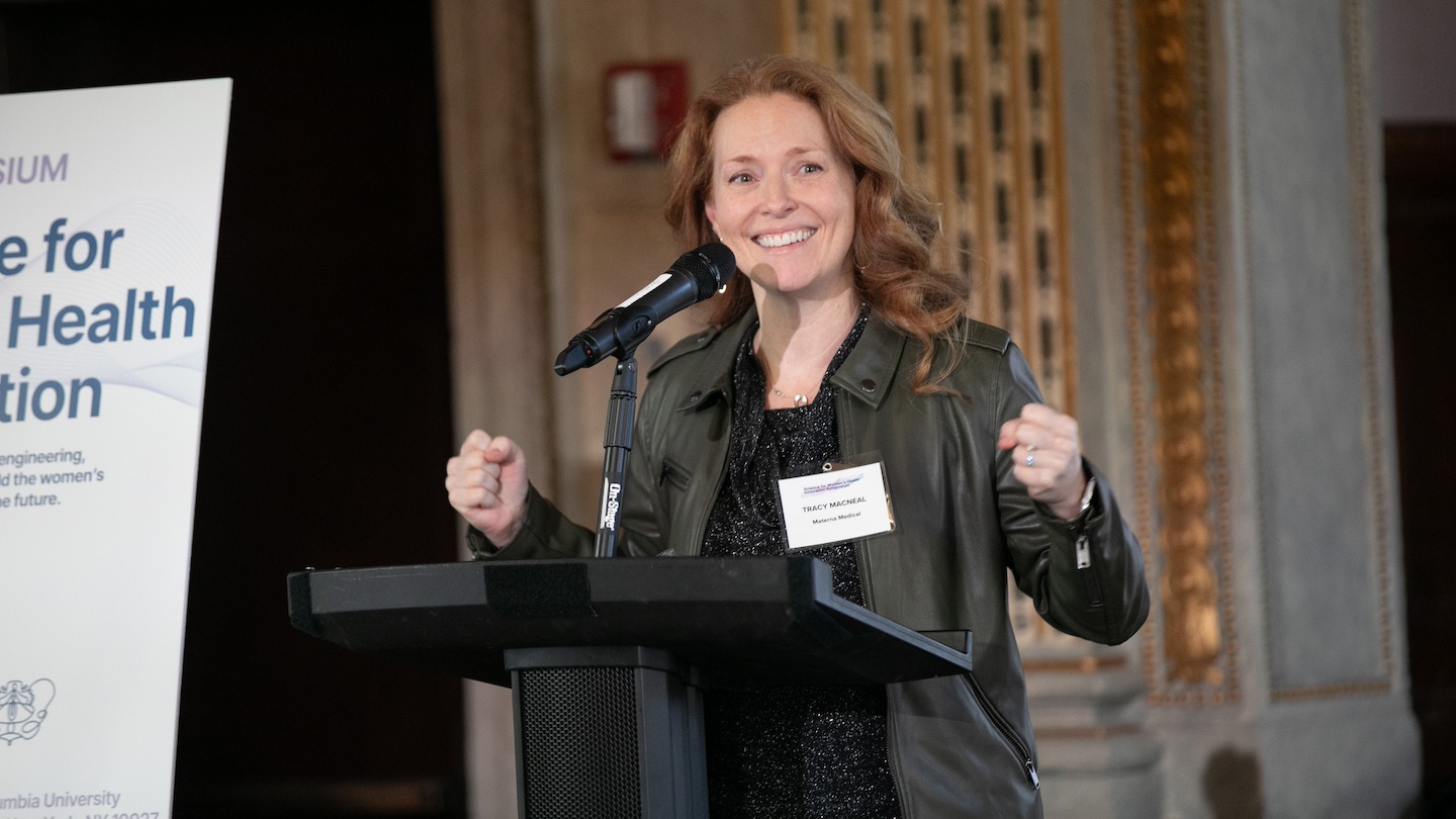 Women's health symposium speaker at podium