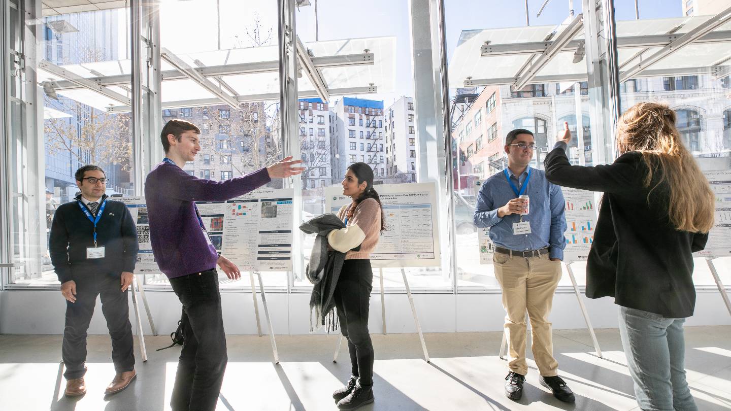 Center for Smart Streetscapes 2026 symposium attendees conversing by research posters