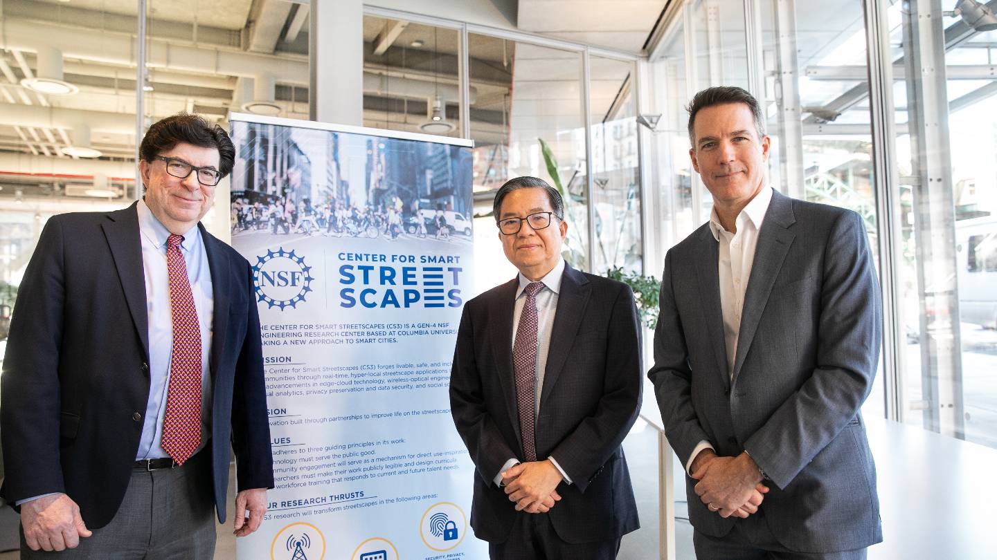 Columbia Engineering Dean Shih-Fu Chang, George Deodatis, and Andrew Smyth posing for a photo next to a poster about the Center for Smart Streetscapes