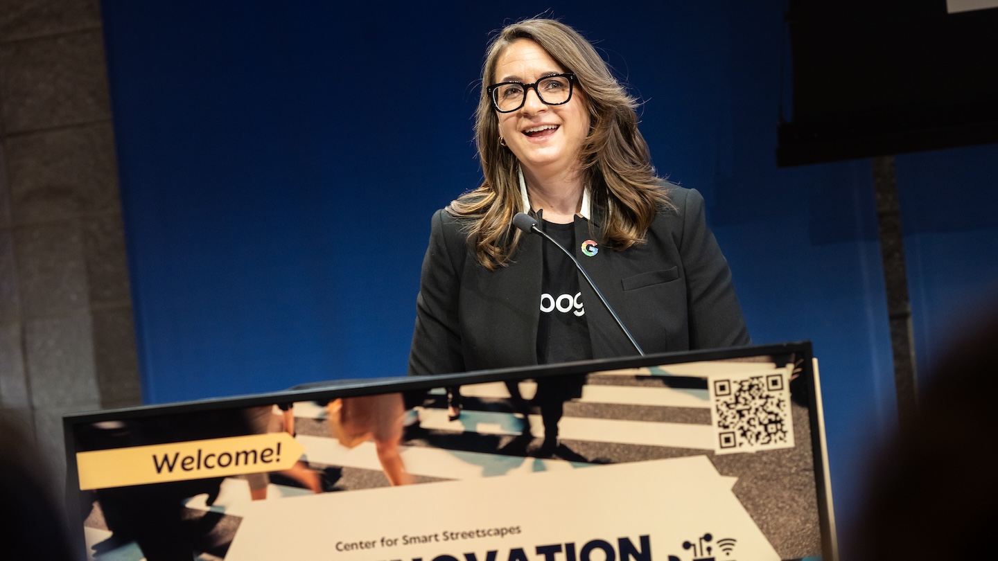 A person stands behind a podium with a microphone