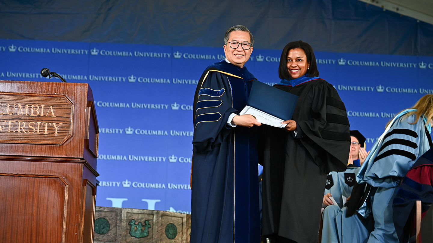 Treena Arinzeh and Dean Shih-Fu Chang in graduation regalia holding up a certificate during the 2026 Columbia Engineering Class Day ceremony