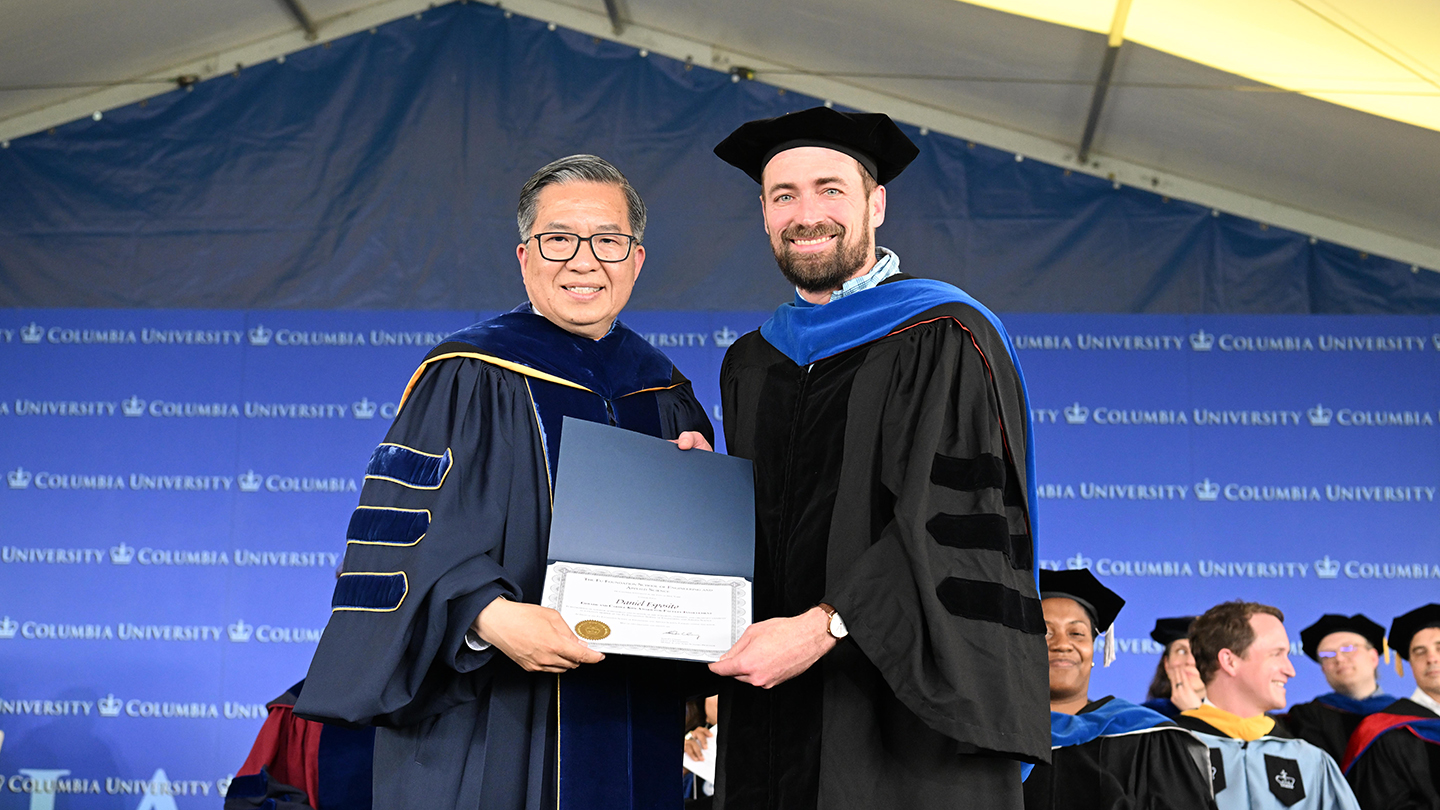 Dean Shih-Fu Chang and Dan Esposito holding up a certificate at the 2026 Columbia Engineering class day ceremony.