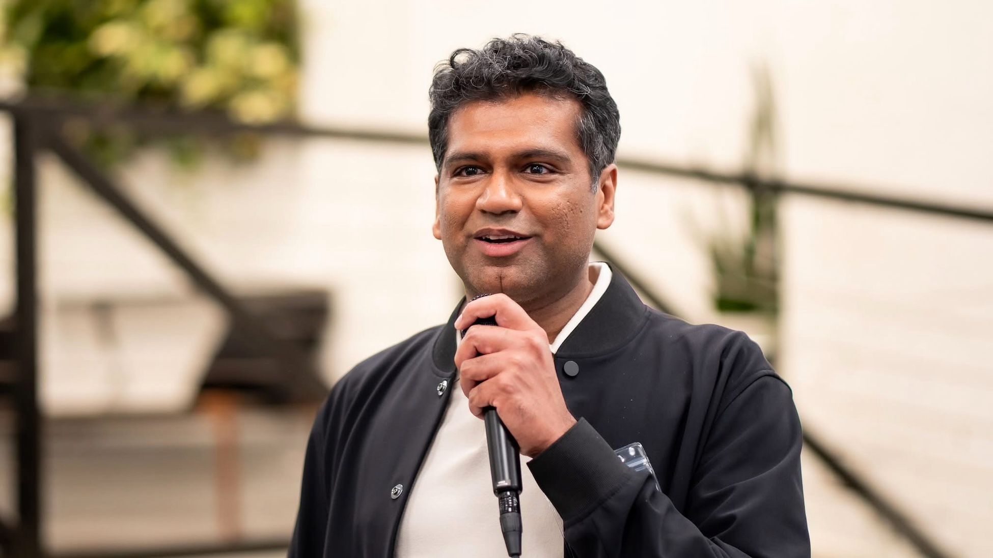 Apoorv Agarwal holding a microphone