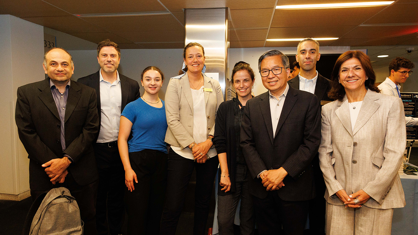 Group photo of event participants standing together in a lobby area.