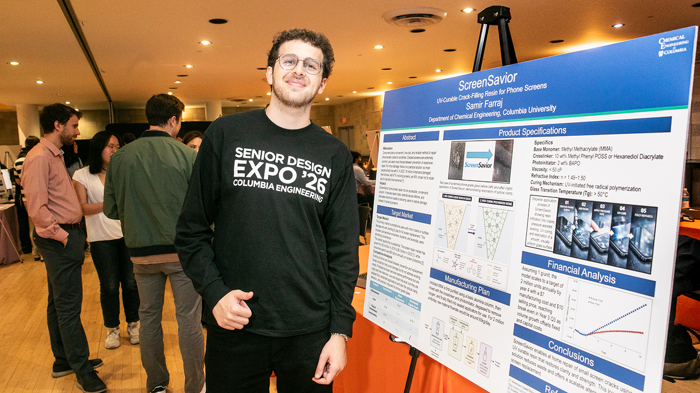 A student wearing a “Senior Design Expo ’26” sweatshirt stands next to a poster about a phone-screen crack-filling resin.