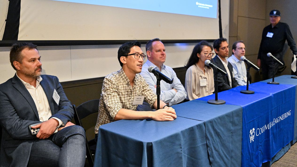 Six panelists from industry and Columbia quantum faculty listen as one speaks into a microphone at a Columbia Engineering–branded table