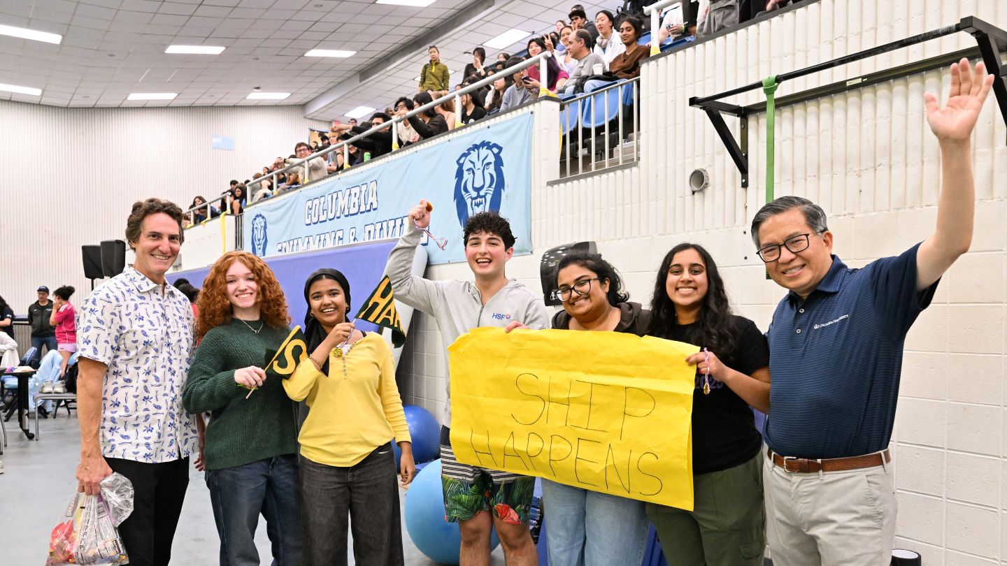 Team Ship Happens, winners of the Best Team Spirit award, pose with Dean Shih-Fu Chang and Vice Dean Barclay Morrison III after the cardboard boat race.