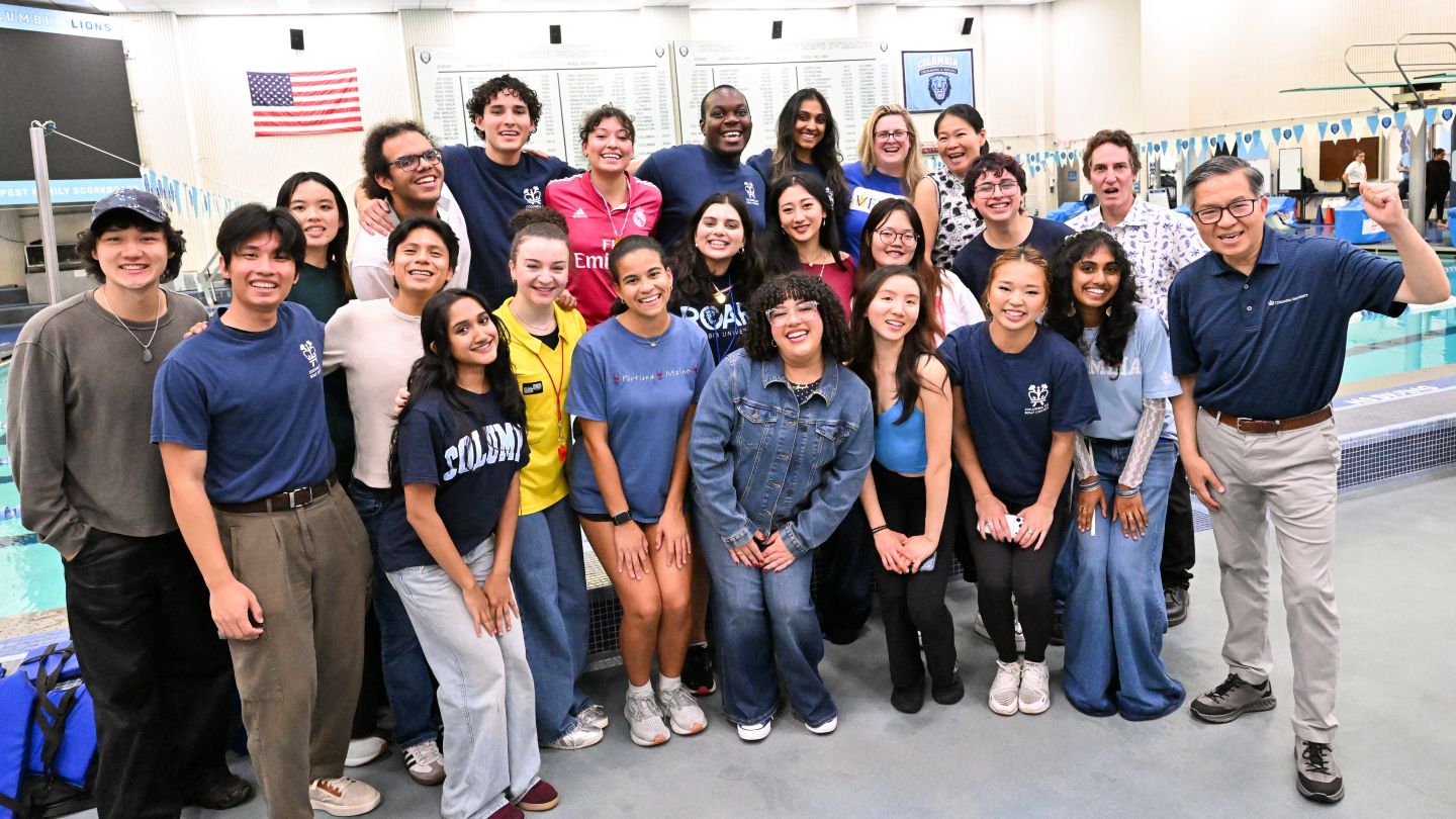 Dean Shih-Fu Chang poses with students and event organizers for a group photo after the cardboard boat race at Uris Pool.