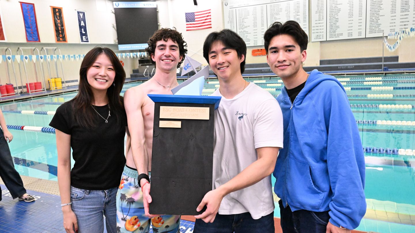 Members of The Promised Pirates pose with the ESC Boat Contest Champions trophy beside Uris Pool.