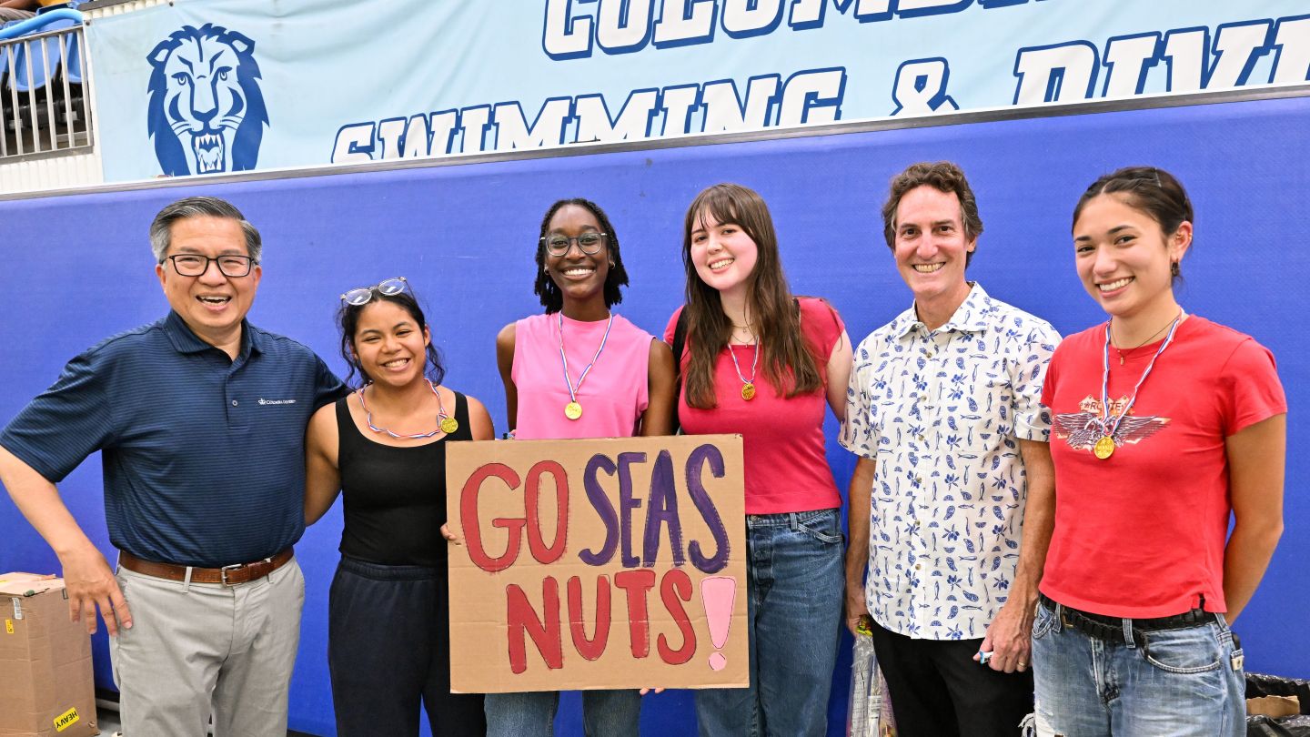 Dean Shih-Fu Chang and Vice Dean Barclay Morrison III pose with Team SEAS Nuts, winners of the Most Creative award, after the cardboard boat race.