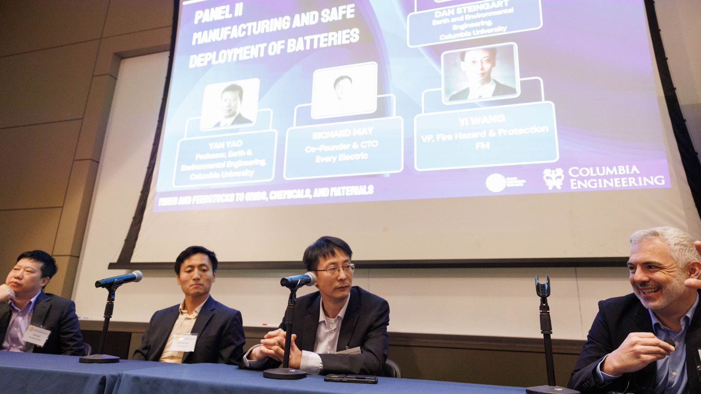 Dan Steingart moderating a panel of three speakers seated beneath a projected presentation at Columbia Engineering.