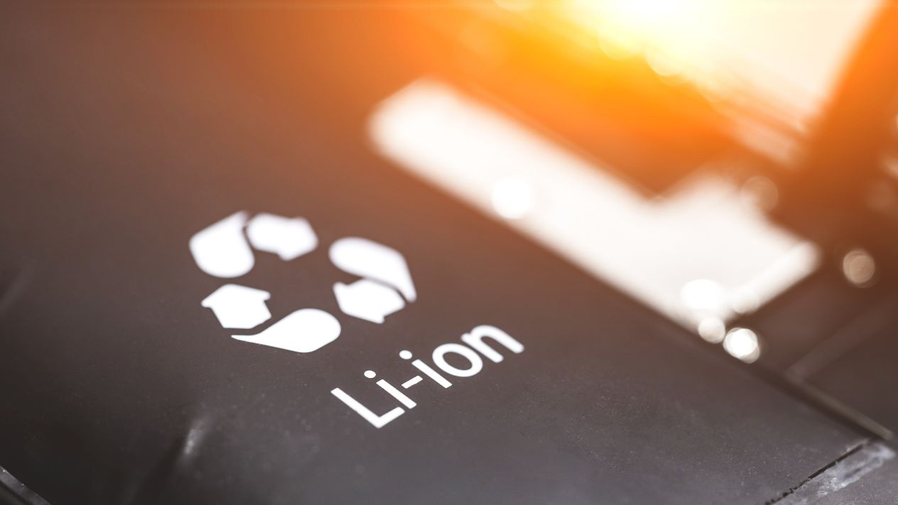Close-up of a lithium-ion battery marked with a recycling symbol.