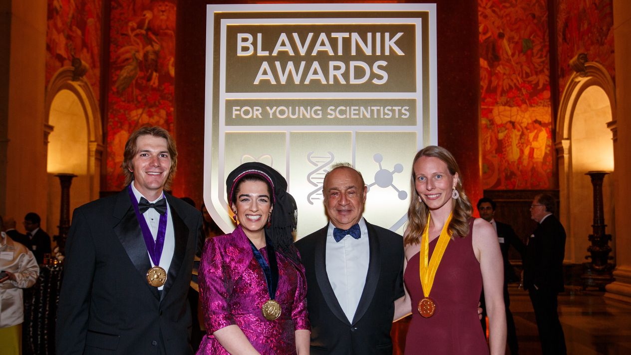 Trevor van Eeuwen, Natalie Fardian-Melamed, Sir Len Blavatnik, and Barbara Bosch pose together at the Blavatnik Awards for Young Scientists ceremony, with van Eeuwen, Fardian-Melamed, and Bosch wearing award medals.