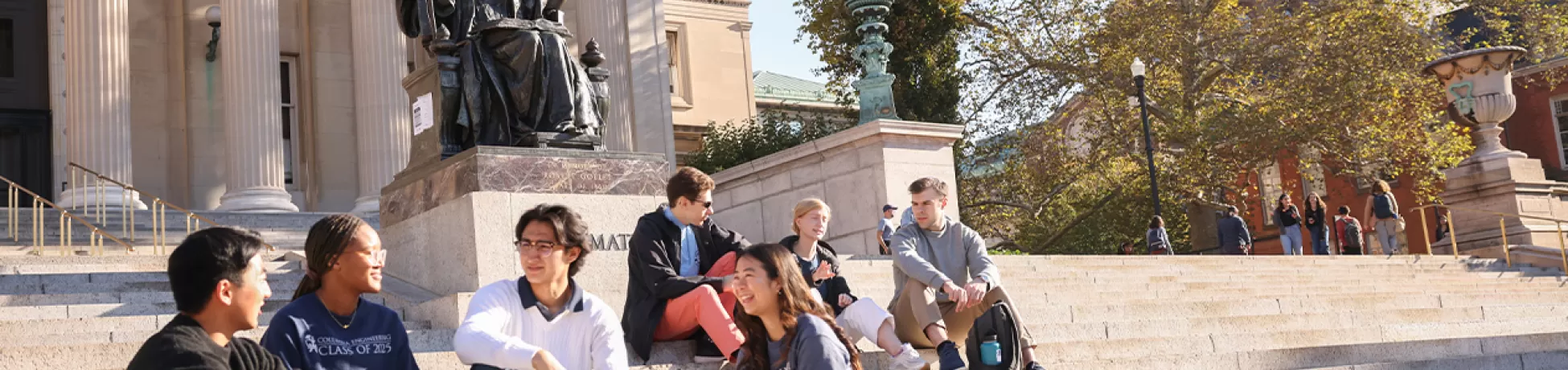 A group of students sitting on steps on campus