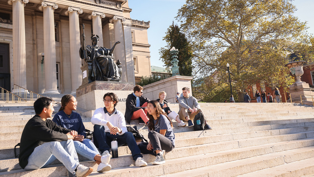 A group of students sitting on steps on campus