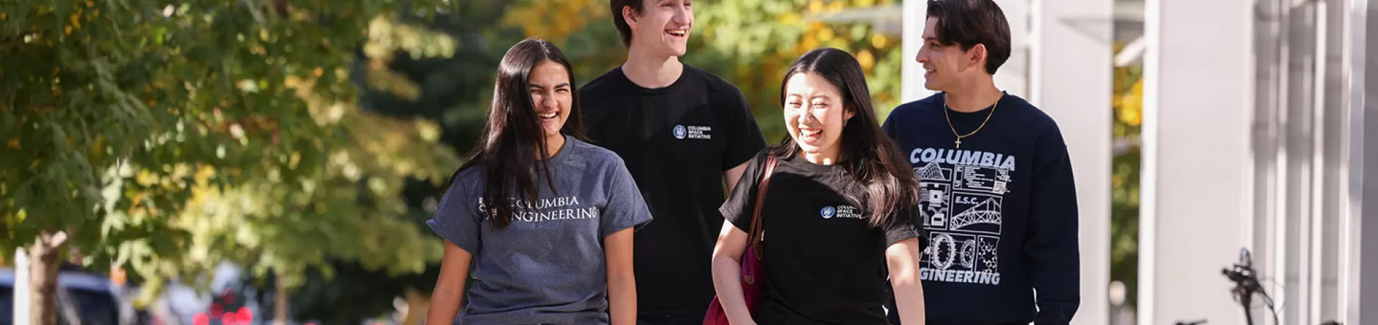 Four Columbia Engineering students walk together down a New York City sidewalk.