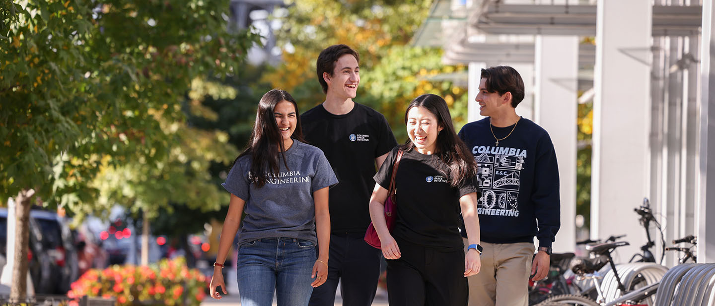 Four Columbia Engineering students walk together down a New York City sidewalk.