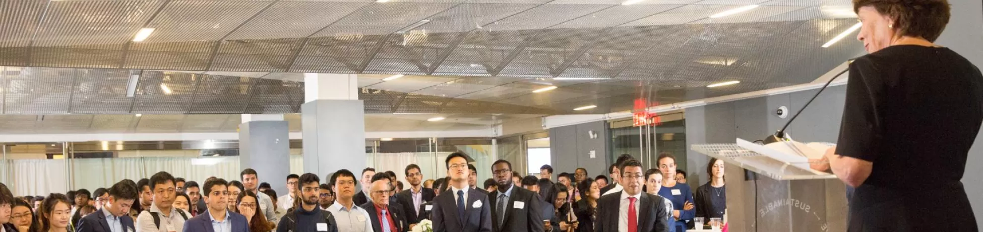 Listeners gathered to hear a keynote speaker standing at a podium.