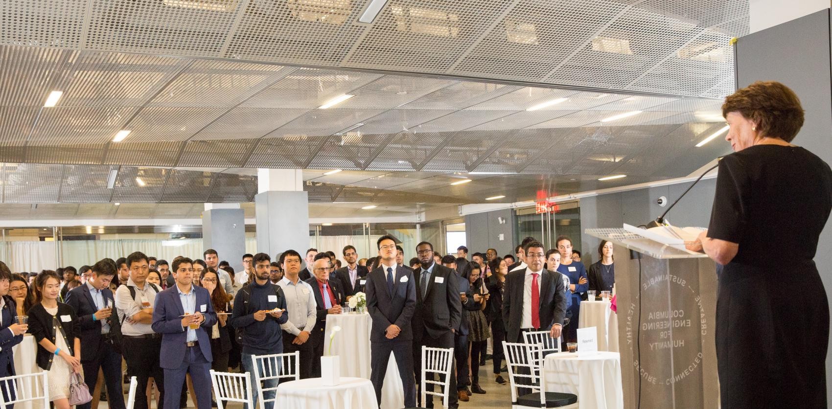Listeners gathered to hear a keynote speaker standing at a podium.