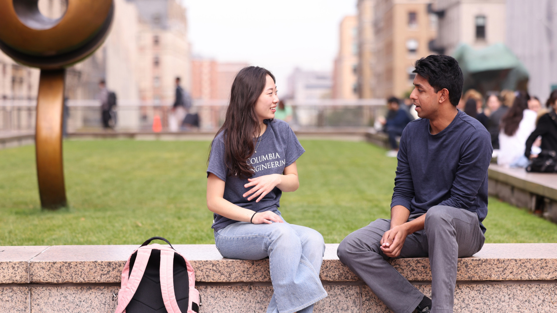 A student talks to an Admissions rep on the lawn at Columbia Engineering.