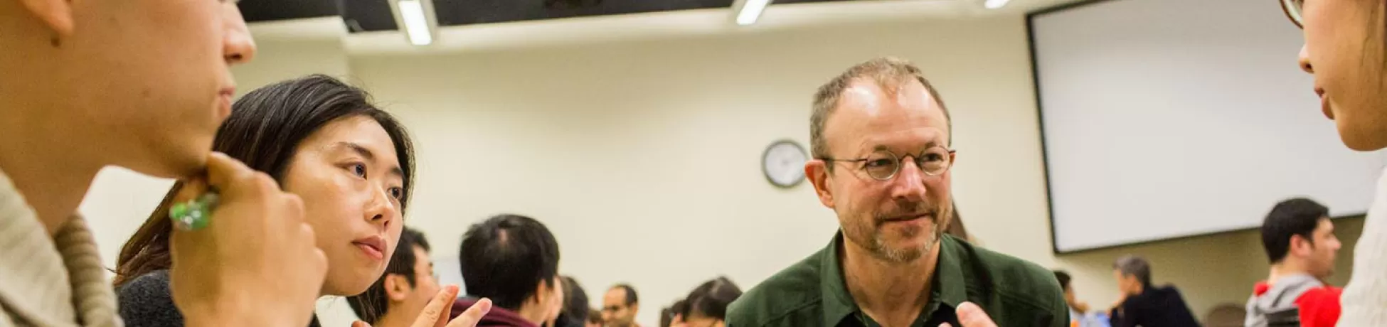 A faculty member sitting at a table with a group of Columbia Engineering students.