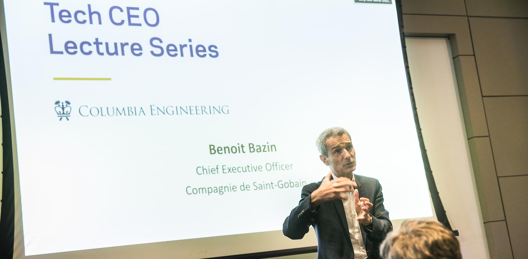 An image of a CEO giving a lecture in front of an audience