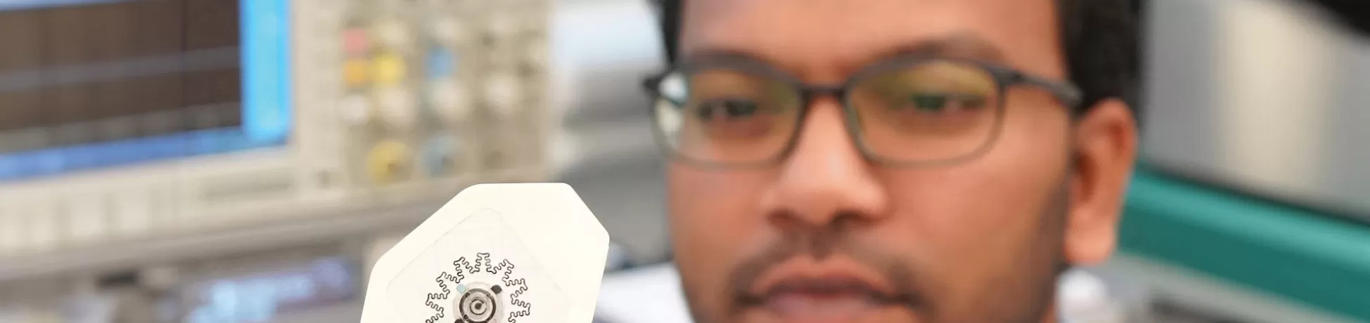 Rajaram Kaveti holding the water-powered, electronics-free dressing for electrical simulation