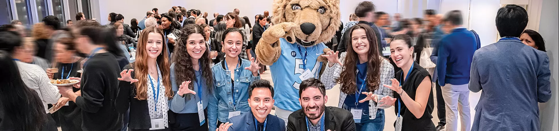 Seven Columbia Engineering alums posing with Roar-ee