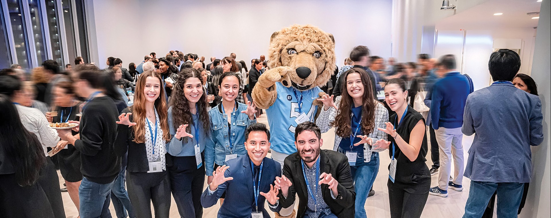 Seven Columbia Engineering alums posing with Roar-ee
