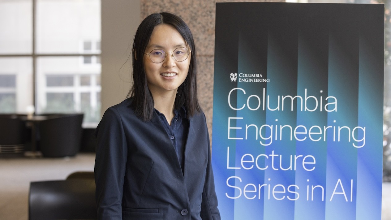Danqi Chen standing next to a sign that reads "Columbia Engineering Lecture Series in AI"