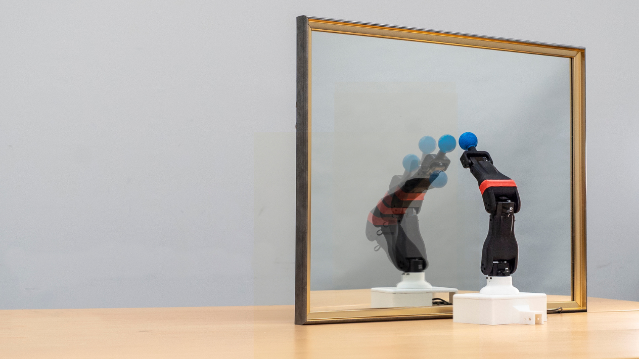 A robot observes its reflection in a mirror, learning its own morphology and kinematics for autonomous self-simulation. 