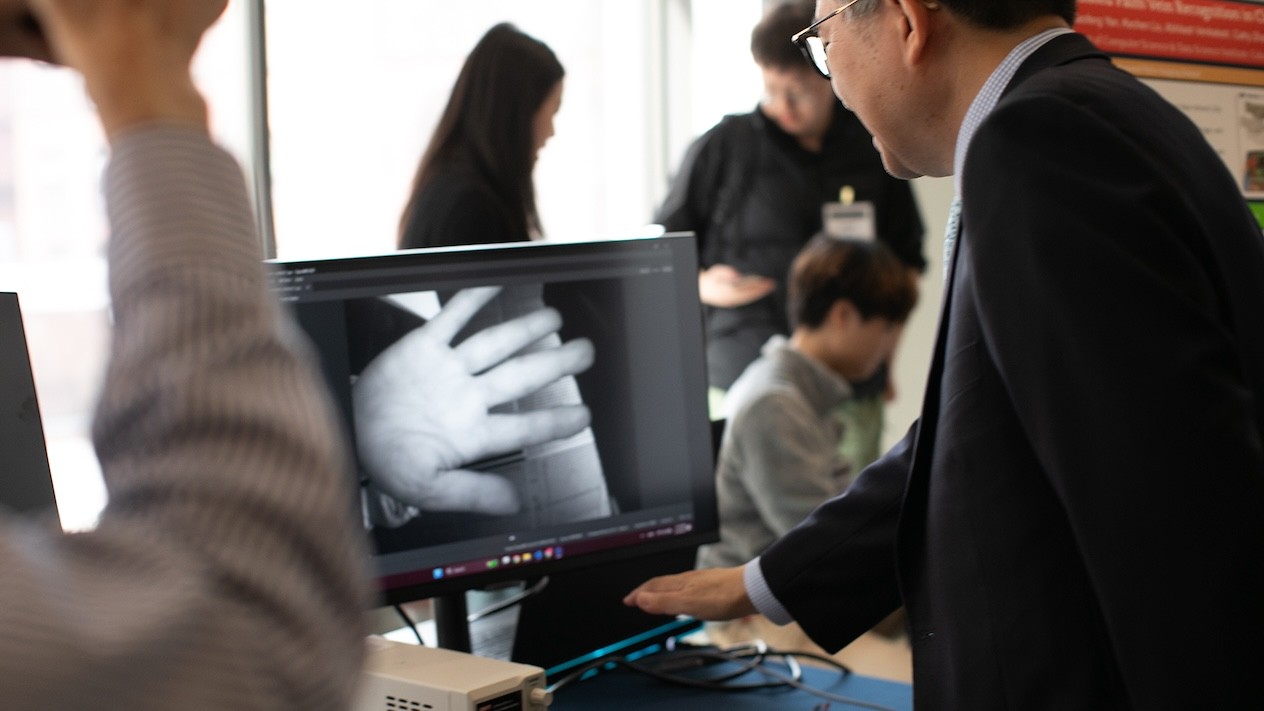 Xia Zhou’s lab showcases hardware prototype for palm vein pattern recognition using near-infrared imaging.
