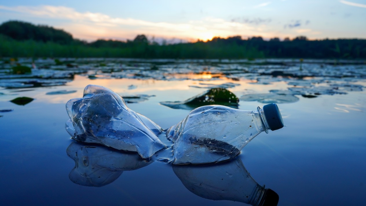 An empty plastic bottle floating in a lake