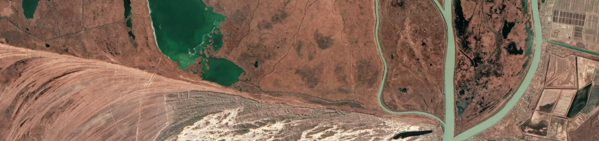 A satellite view of a river carving through the surrounding landsacpe