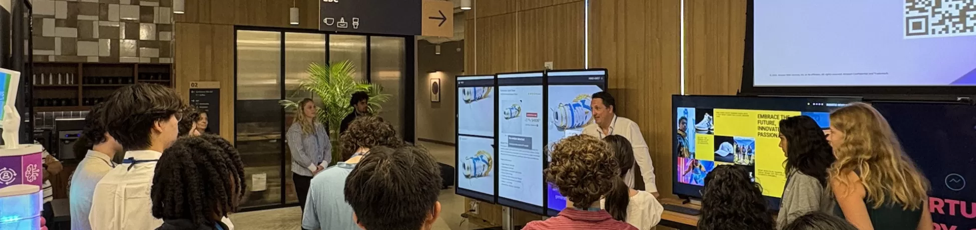 people gathered around large screen displaying information