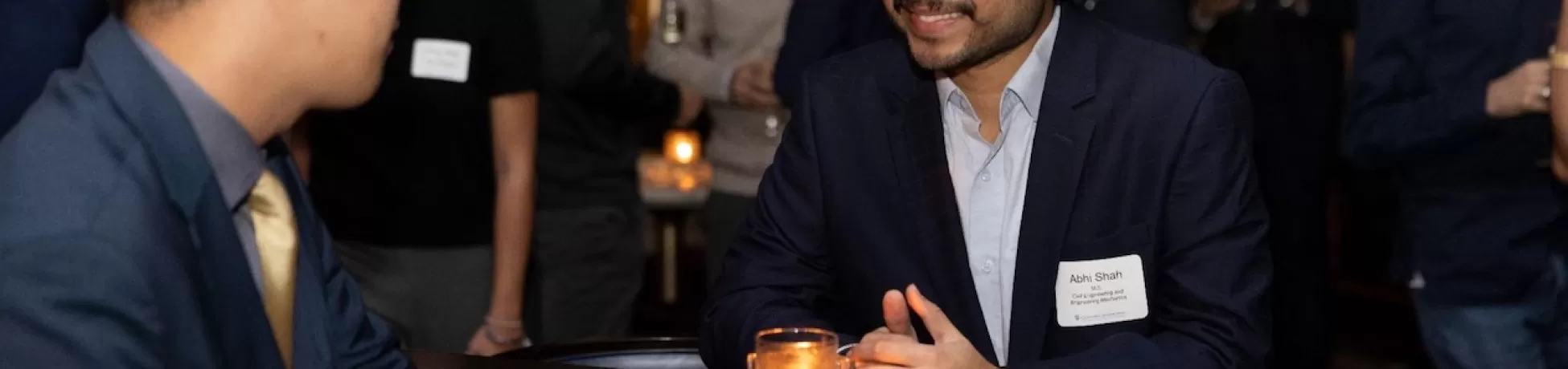 two people speaking at an event