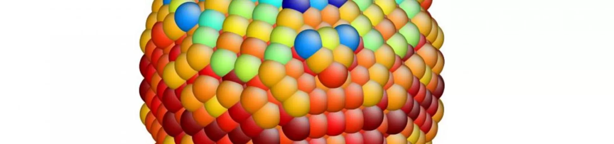 Three-dimensional rendering of a spherical structure made up of tightly packed, multicolored spheres arranged in a repeating pattern.