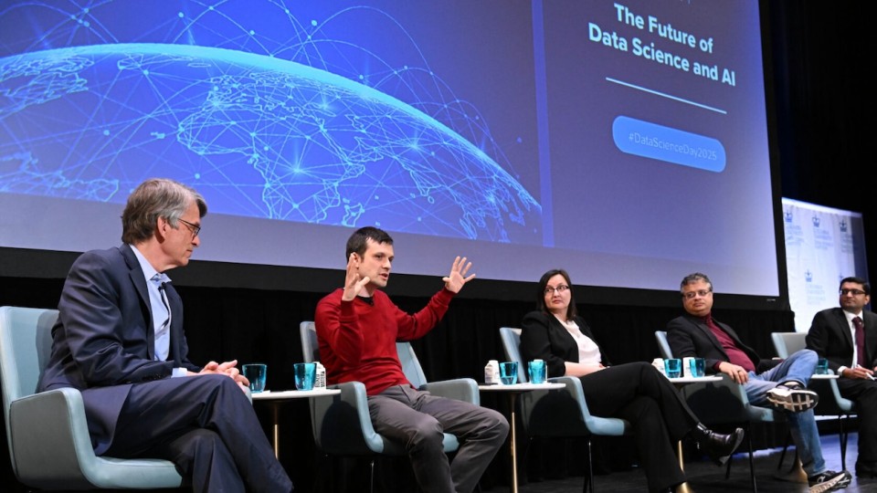 Five panelists sitting on stage in front of a screen that reads "The Future of Data Science and AI"