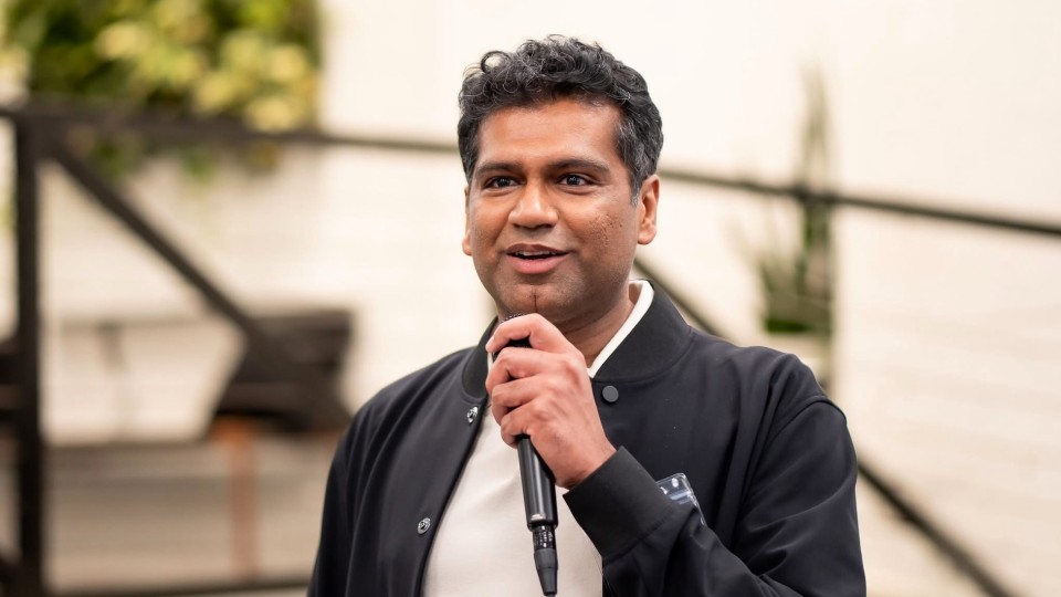 Apoorv Agarwal holding a microphone
