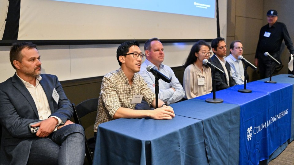 Six panelists from industry and Columbia quantum faculty listen as one speaks into a microphone at a Columbia Engineering–branded table