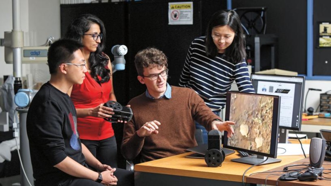 Carl Vondrick (center) with researchers in his lab.