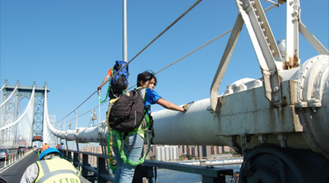 Two men working on a bridge