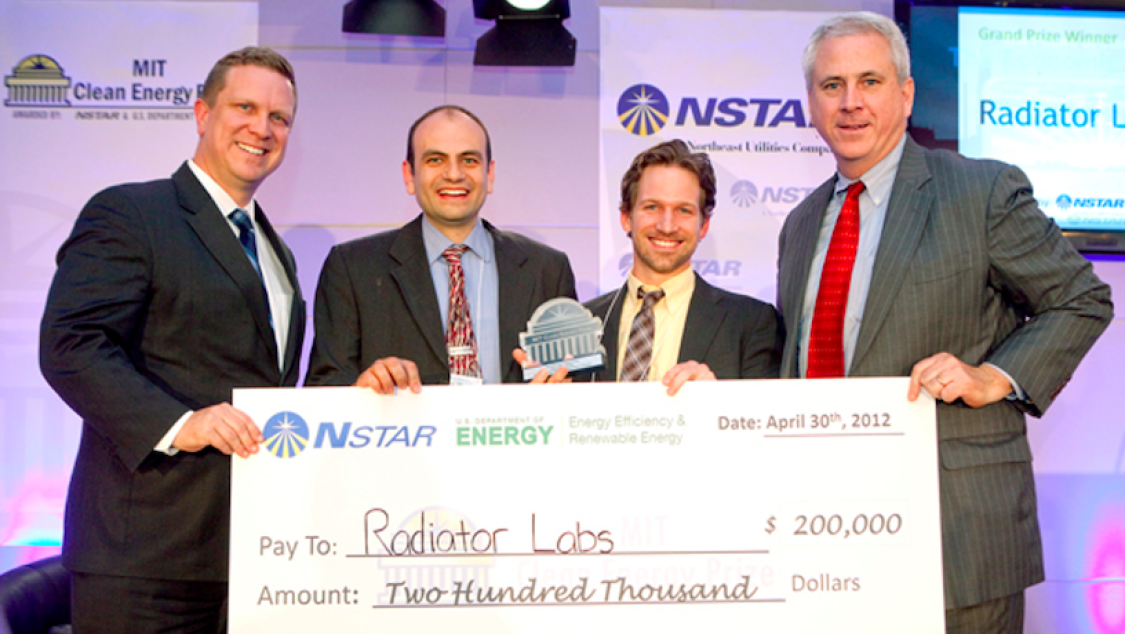 Cox and advisors being awarded a giant check.