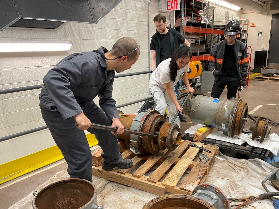 Civil Engineering student, Angelina Wu, and the Carleton Lab team working on restoring the old pump system.
