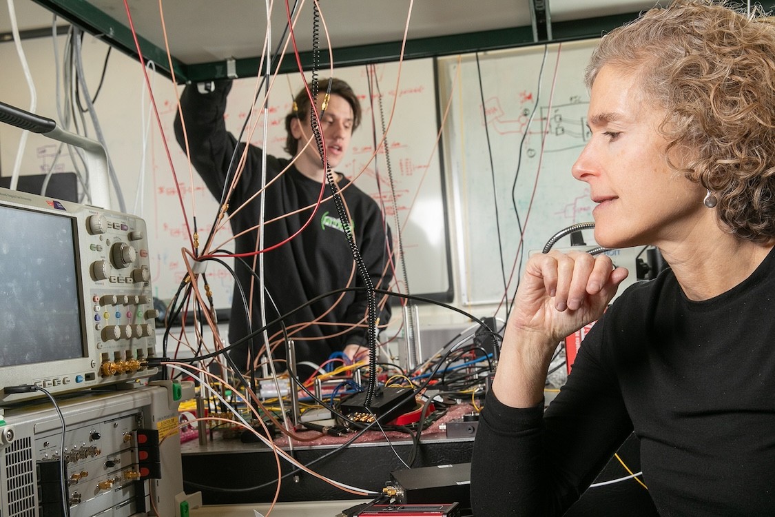 Two people in a wire-strewn research lab.