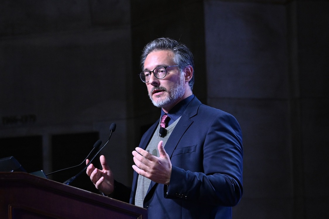Sami Haddadin speaking at a podium.