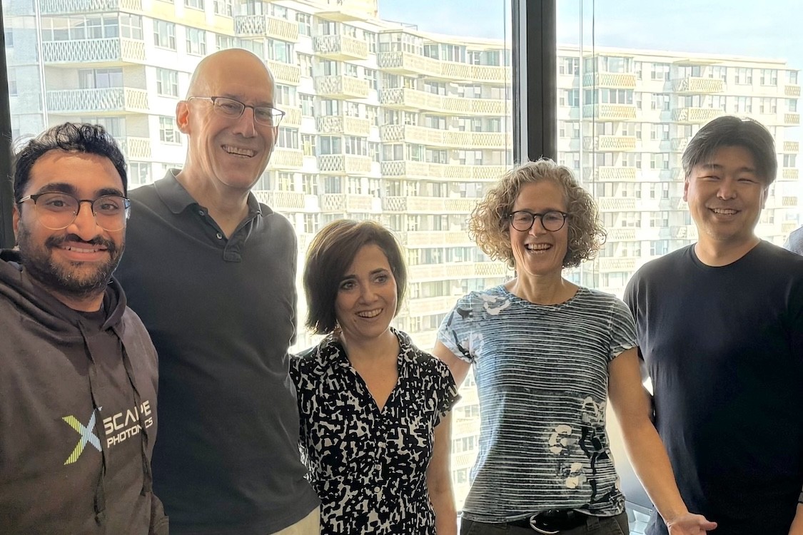 Five people smiling for a photo