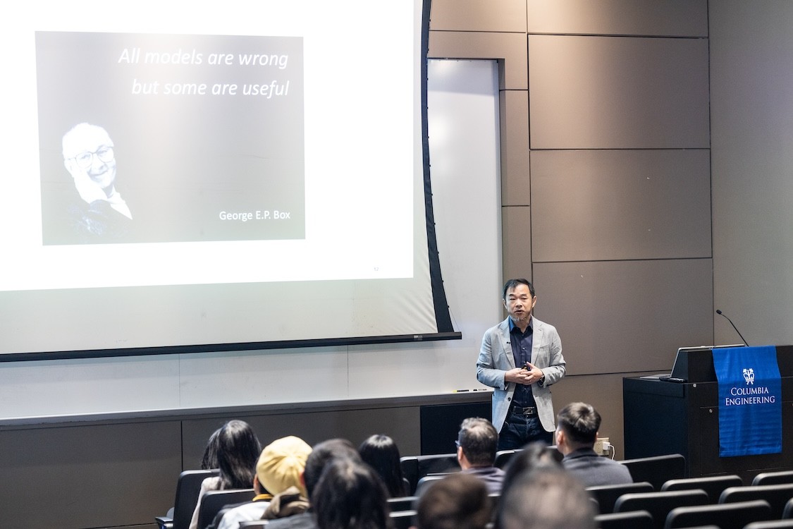 Eric Xing presenting in front of a lecture hall